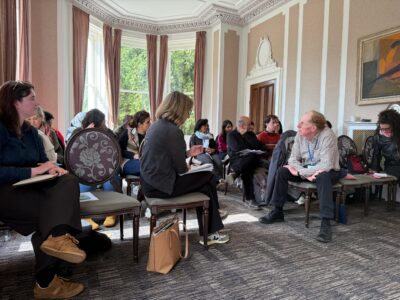 Workshop participants seated on chairs listening to speaker